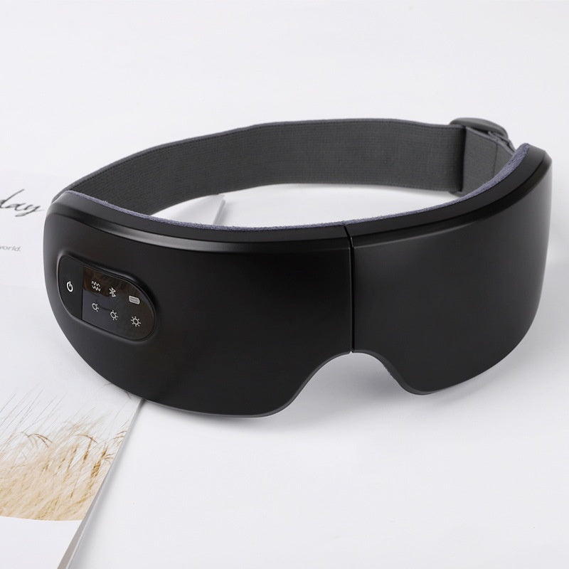 Aparelho de massagem ocular com terapia de calor e vibração, máscara ocular dobrável e recarregável para uso doméstico.