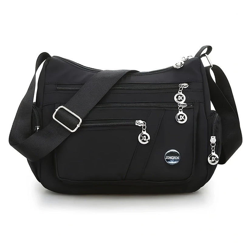 Bolsa transversal feminina com vários compartimentos, leve e com grande capacidade.